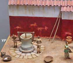 Atelier de meunier gallo-romain avec moulin à grains en pierre